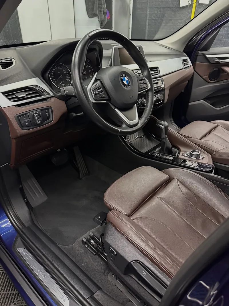 Interior BMW X1 cu scaune maro din piele după curățare